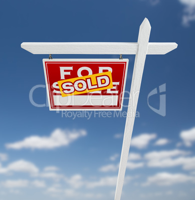 Left Facing Sold For Sale Real Estate Sign on a Blue Sky with Cl