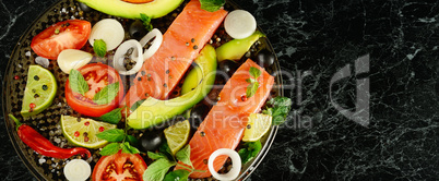 Fillet of red fish and spices on a black background. Free space