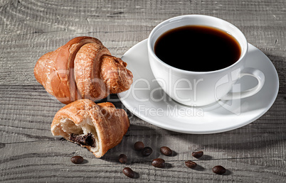 Coffee and croissants on a wooden table