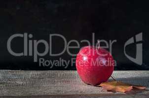 Red ripe apple on a wooden table