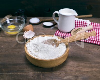 white wheat flour in a wooden bowl