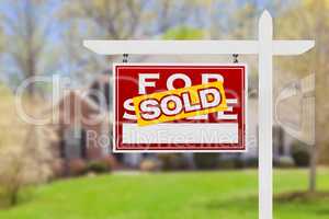 Left Facing Sold For Sale Real Estate Sign In Front of House.