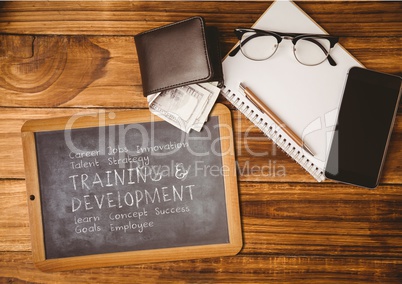 Business supplies and blackboard with plan written on it