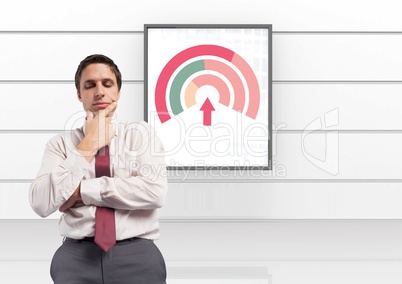Businessman thinking with colorful chart statistics on board on wall