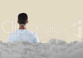 Teenager looking forward with clouds behind him