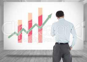 Businessman standing with colorful chart statistics on whiteboard
