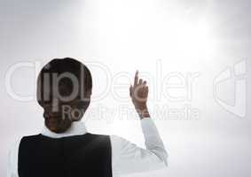 Businesswoman pointing at bright background