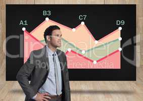 Businessman and black screen with colorful chart statistics