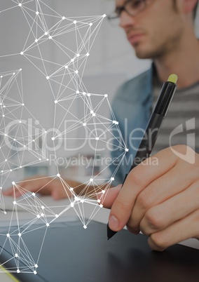 Business man using graphic tablet with graph overlays