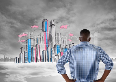 Man looking at doodle of city with city in far background