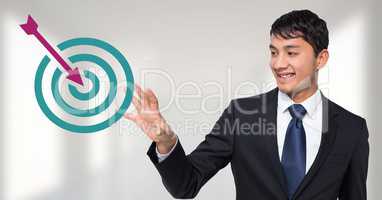 Businessman interacting with target and arrow icons
