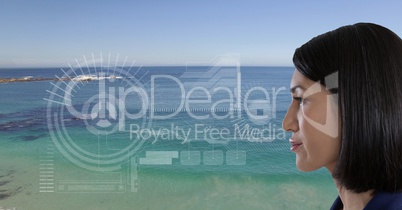 Woman looking at interface screen near sea