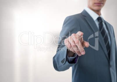 Businessman pointing with bright background