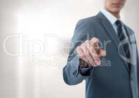 Businessman pointing with bright background