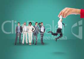 Hand choosing a man on a green background with business people