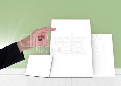 Hand pointing at blank white canvas