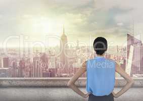 Woman standing hands on hips looking across skyline