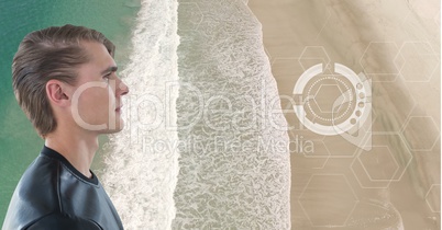 Man looking at interface screen on sandy beach