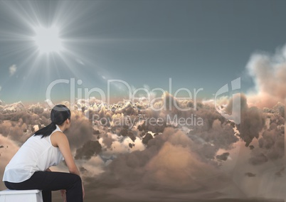 Business woman looking across clouds at something