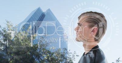 Man looking at building with interfaces over head