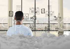 Teenager standing looking at doodle in office with clouds behind him
