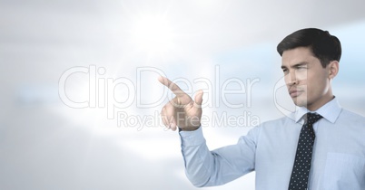 Businessman pointing with bright background Businessman pointing with bright background