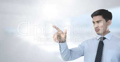 Businessman pointing with bright background