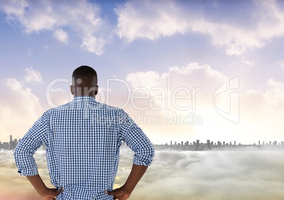 Man looking out at colourful city skyline with smoke in front of him