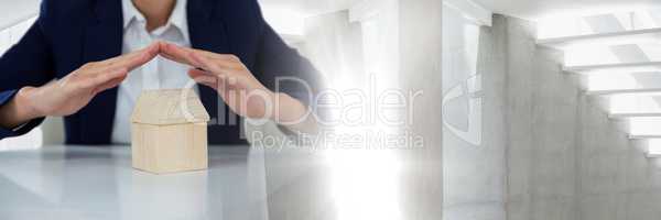 Home model under business persons hands protected