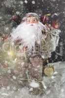 Santa Claus Outdoors Beside Christmas Tree in Snowfall Carrying