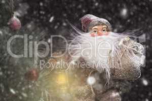 Santa Claus Outdoors Beside Christmas Tree in Snowfall Carrying