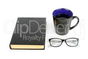 Book, cup with tea and glasses isolated on white background.