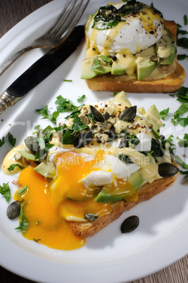 Eggs Benedict with avocado on toast