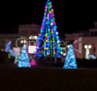 blurred background with a Christmas tree on a city square