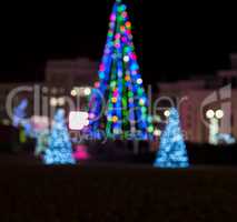 blurred background with a Christmas tree on a city square