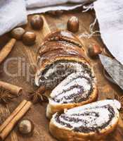 baked roll with poppy seeds on a wooden board
