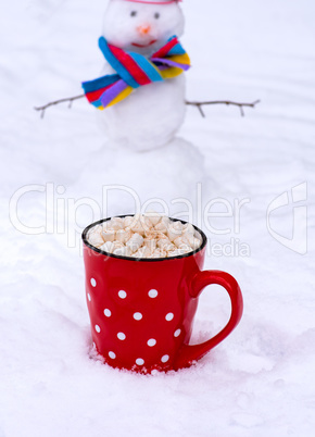 red ceramic mug with hot chocolate and marshmallow