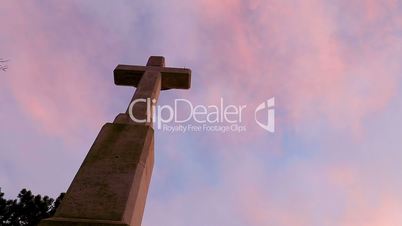 Quick clouds on the sunset sky over the big cross, time lapse