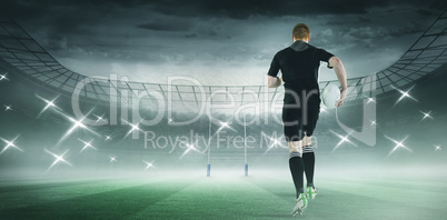 Composite image of rugby player running with a rugby ball