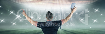 Composite image of rugby player celebrating with the ball