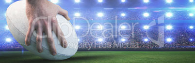 Composite image of rugby player posing feet on the ball