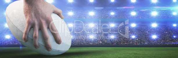 Composite image of rugby player posing feet on the ball