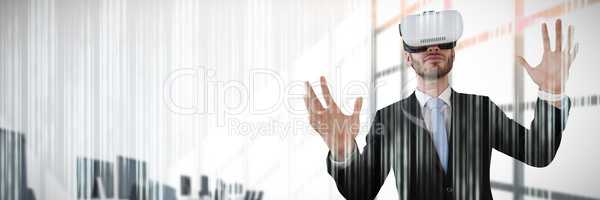Composite image of businessman with vr glasses gesturing against white background