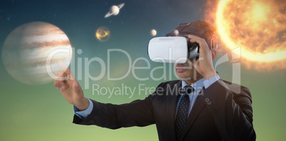 Composite image of businessman gesturing while using vr glasses