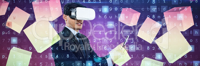 Composite image of businessman using tablet while wearing vr glasses