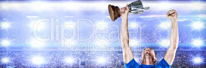 Composite image of happy rugby player holding trophy