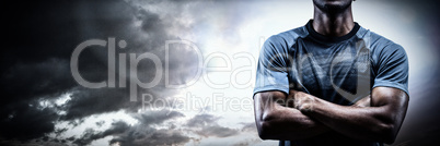 Composite image of thoughtful athlete standing with arms crossed