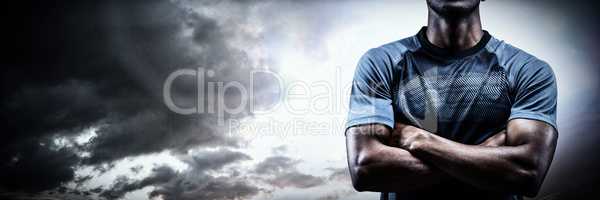 Composite image of thoughtful athlete standing with arms crossed