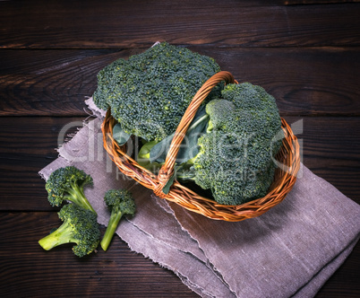 raw green cabbage broccoli in brown wicker basket