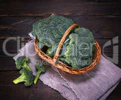 raw green cabbage broccoli in brown wicker basket